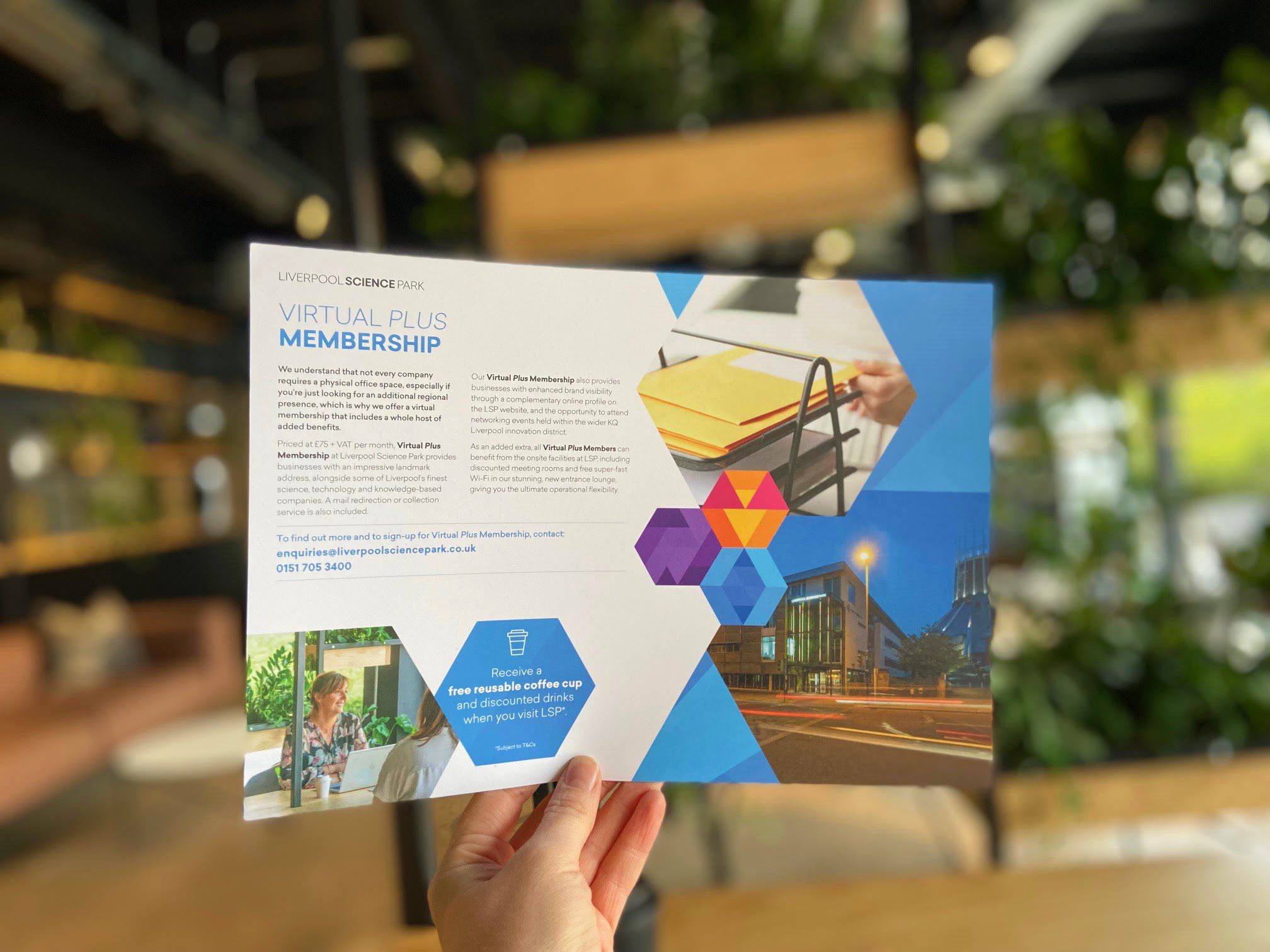 A hand holding a leaflet on Virtual Plus Membership