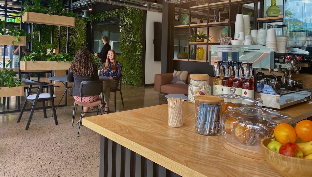 The entrance room with desks and coffee machine