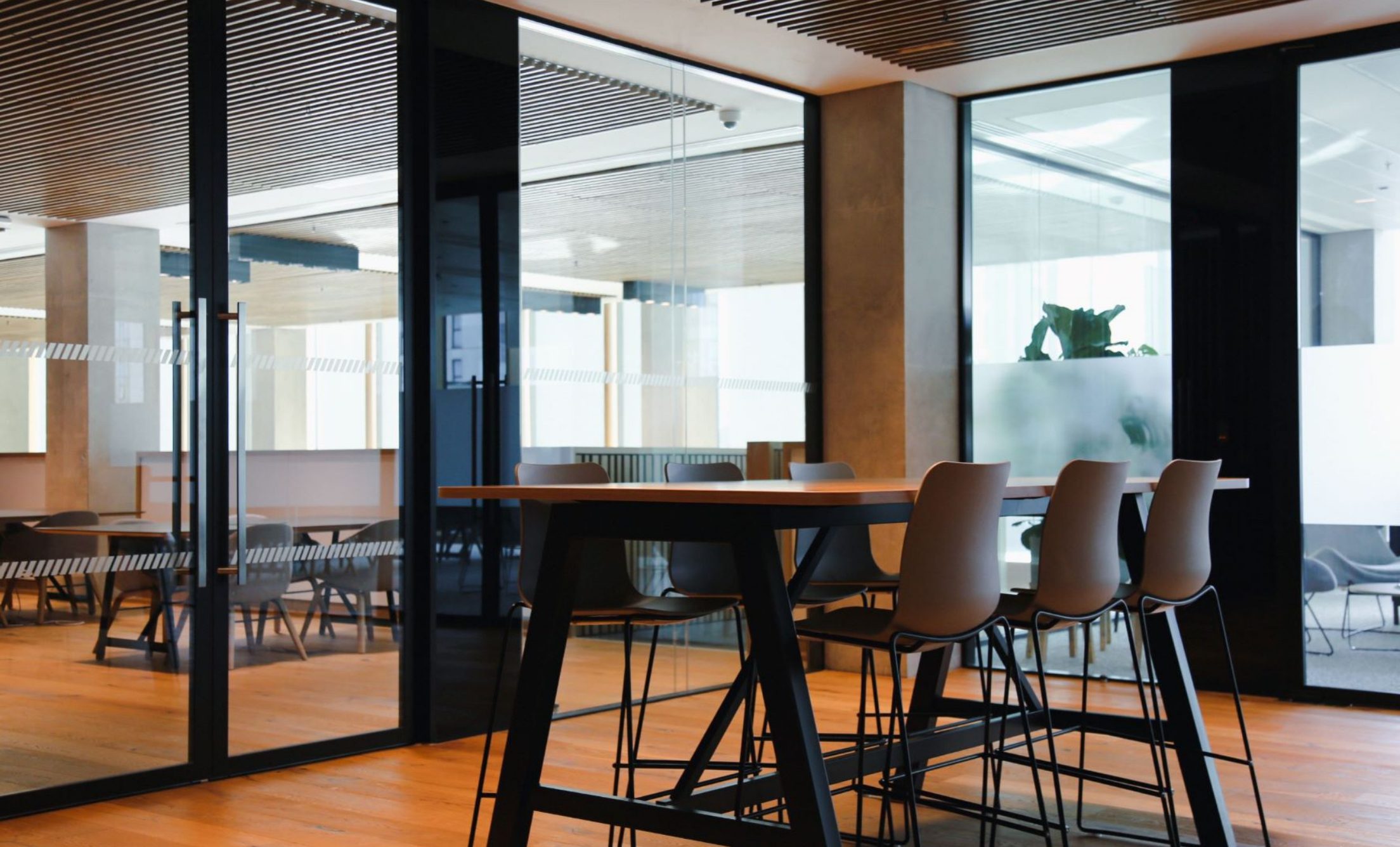 An empty office space with stools at a table