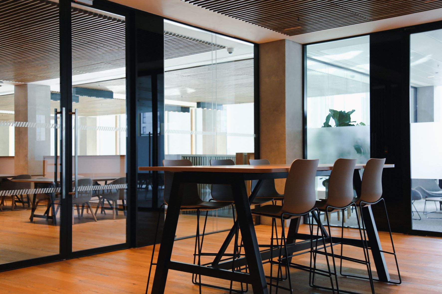 An empty office space with stools at a table